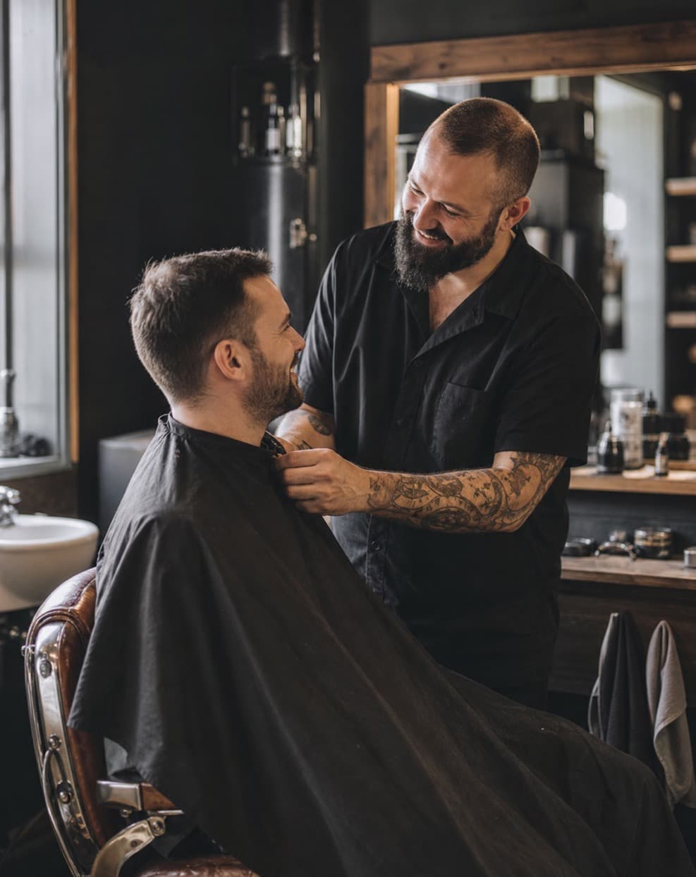 A barber sharing a familiar moment with a returning client